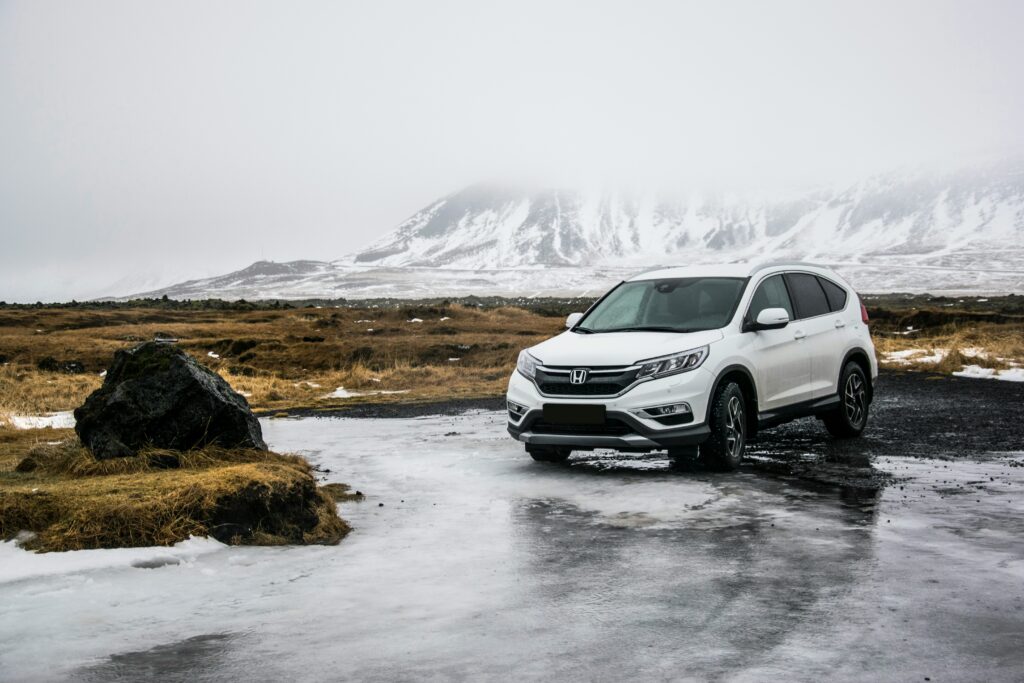 A Honda CR-V parked on a snowy road, showcasing its ability to handle winter conditions.