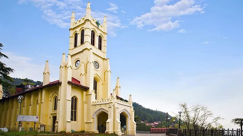 Christ Church Shimla, a historic yellow Anglican church with a tall spire.